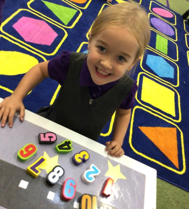 Child playing with numbers and smiling