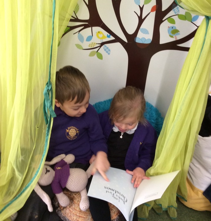 Children reading a book together