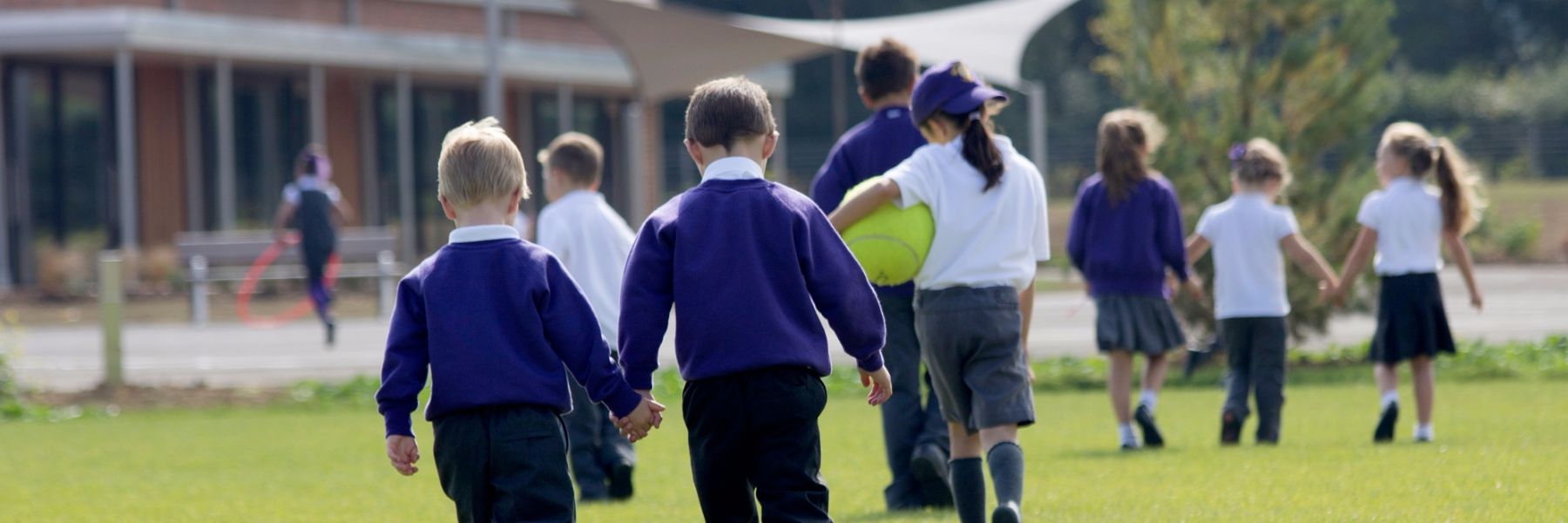 Children holding hands on field